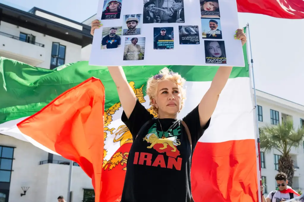 Amal Karsaz protests outside SoFi Stadium before the start of...