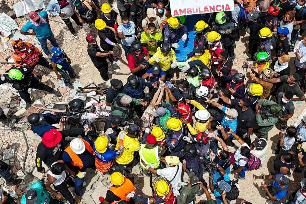 A person removed from the rubble by members of the...