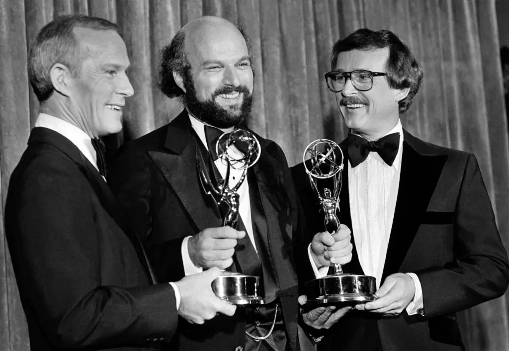 Tom Smothers, left, and his brother Dick, right, flank director...