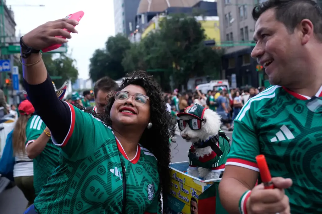 A fan, left, takes a photo with a dog named...