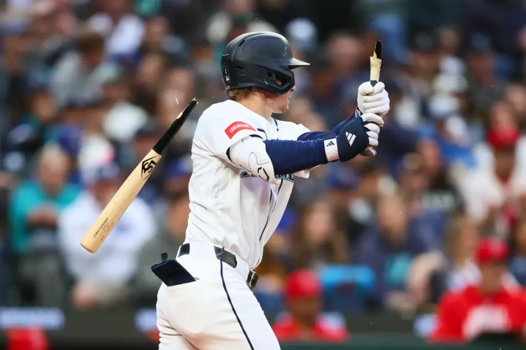 The Seattle Mariners’ Colt Emerson breaks his bat on a...