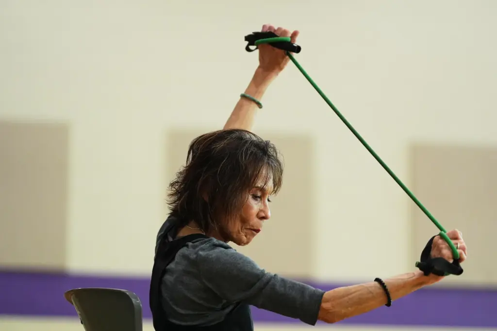 Instructor Bengie Santos, 72, leads a class for older adults.