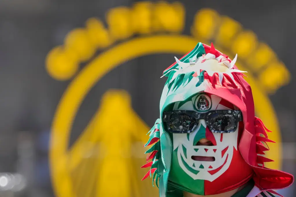 A Mexico fan waits to watch a public viewing of...