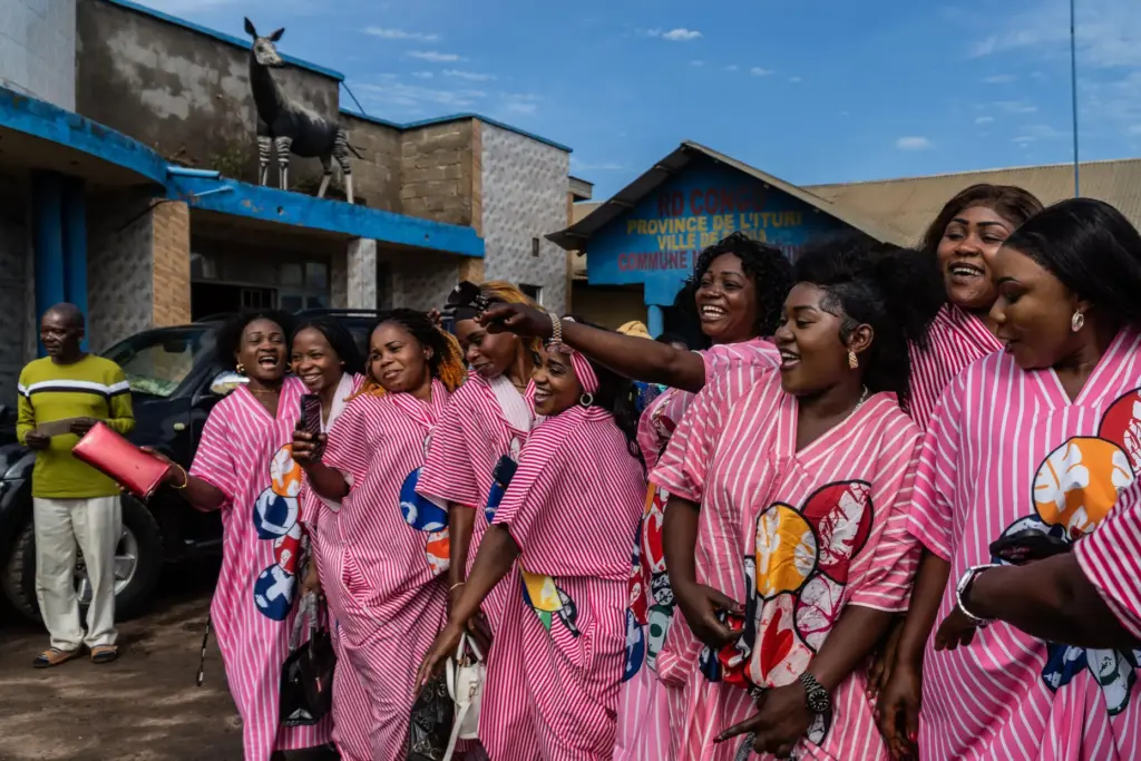 Wedding guests cheer at a wedding ceremony amid an Ebola outbreak.