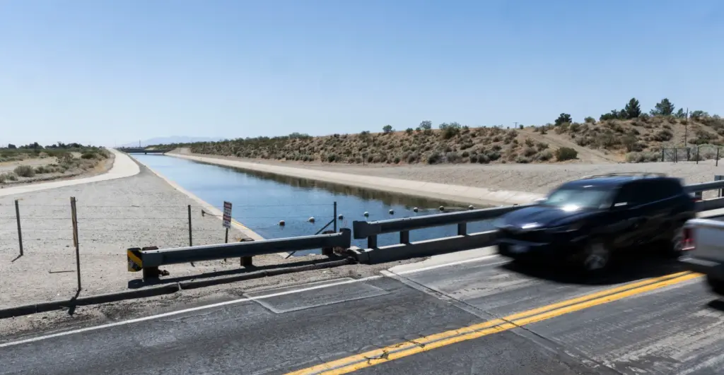 Cars drive along Sheep Creek Road and over the California...