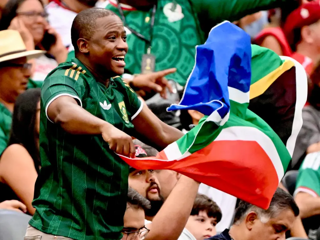 A South Africa fan waves his flag prior to a...
