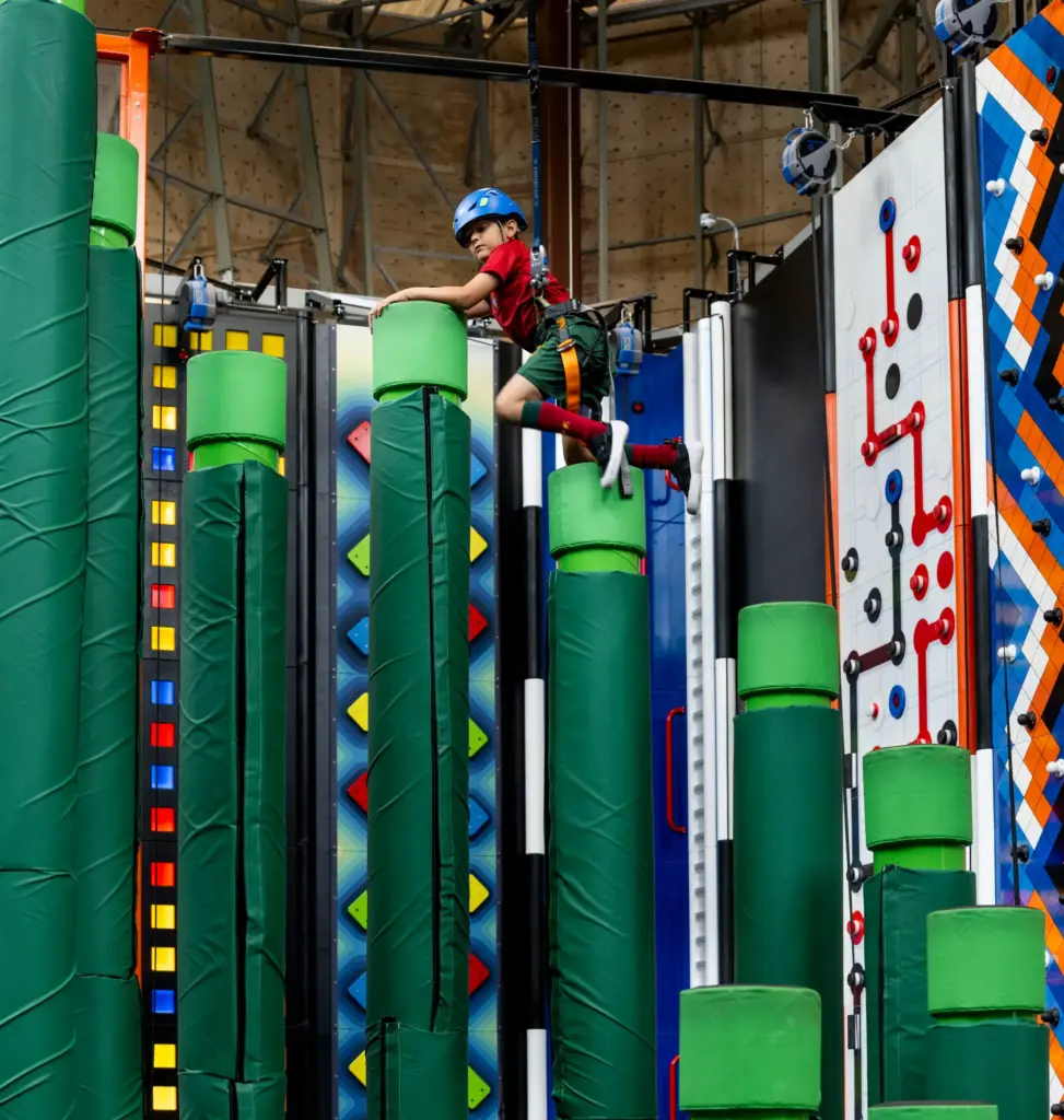 Pasha Omrani, 7, climbs an obstacle in Sender City during...