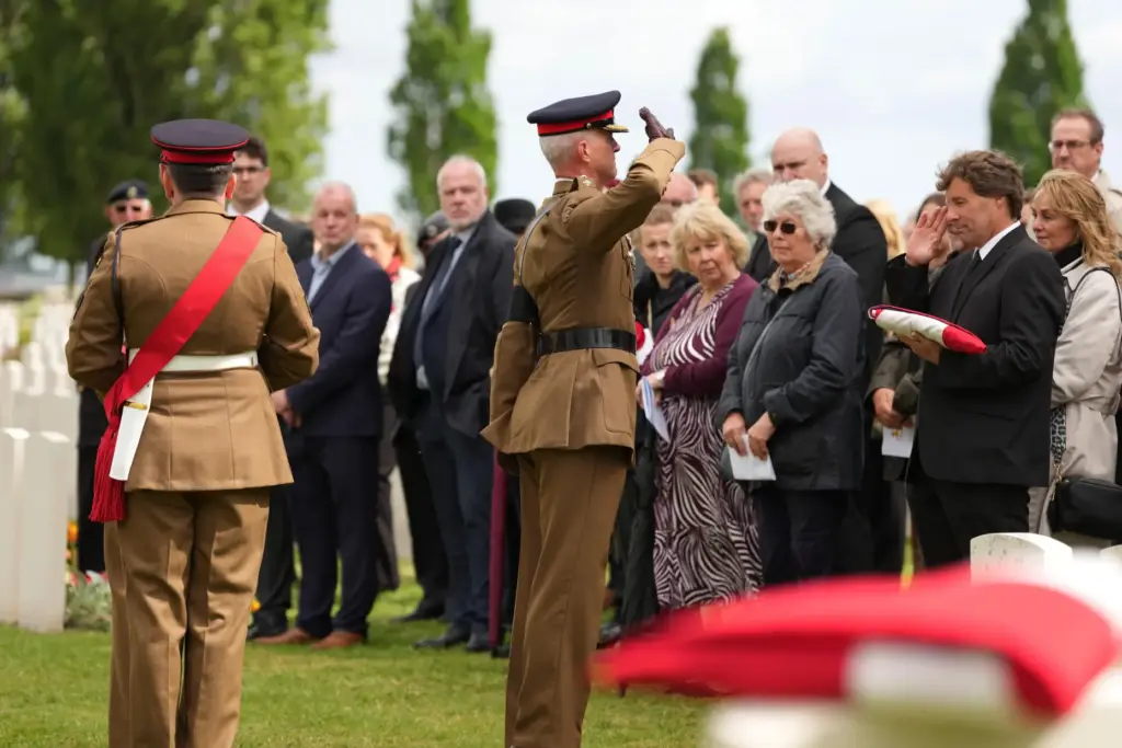 Folded flags are presented to relatives during a burial ceremony...