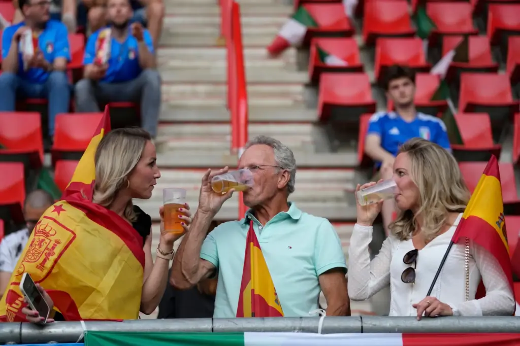 Fans have a drink on the stands while waiting for the start of the Nations League semifinal.
