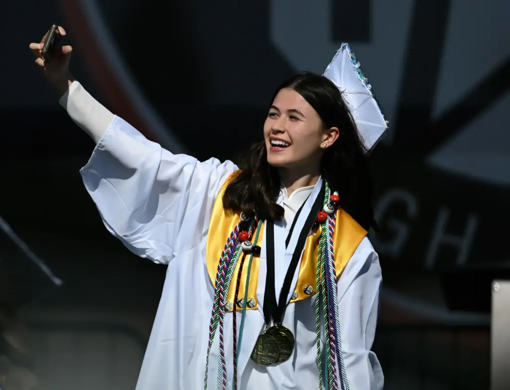 Katie Mueller, Summa Cum Laude, captures the moment on camera...