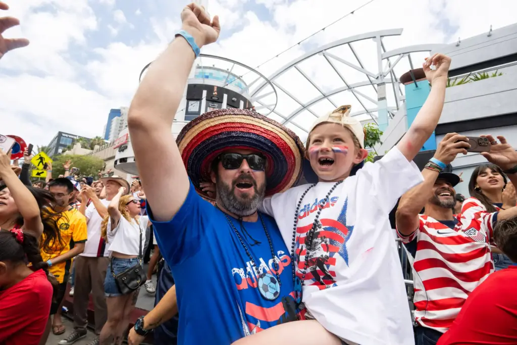 From left, Anthony Falcon and five-year-old Arrow Falcon celebrate U.S.A.âs...
