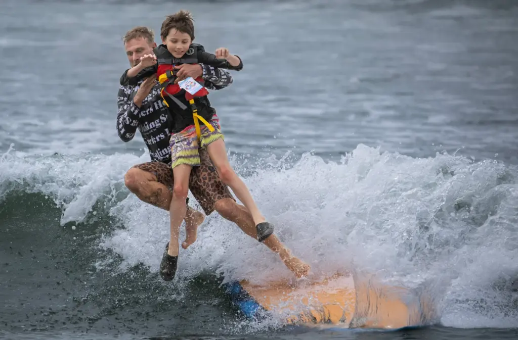 Maverick Meadows, 11, and a Surfers Healing volunteer, hit the...