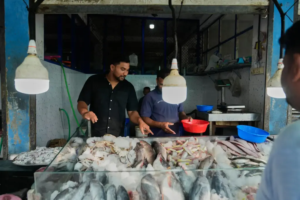 Safeer Mohammed Koorimannil walks through a wholesale fish market.