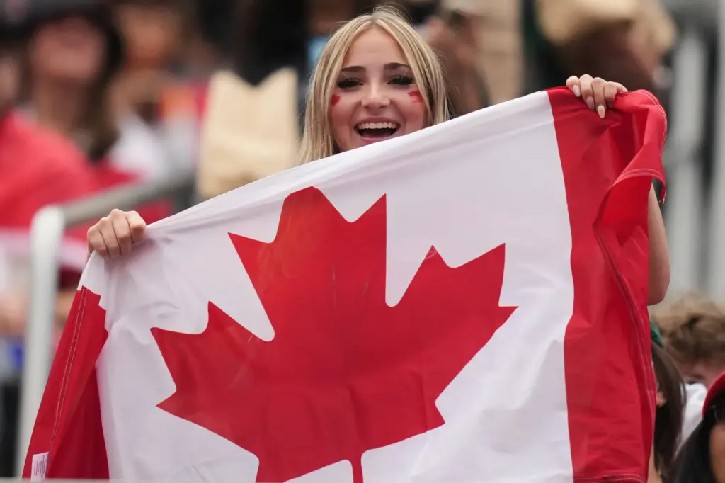 A fan of Canada waits for the start of the...