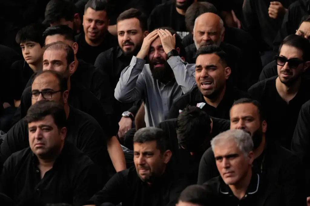People weep during a mourning ceremony in Tehran, Iran.