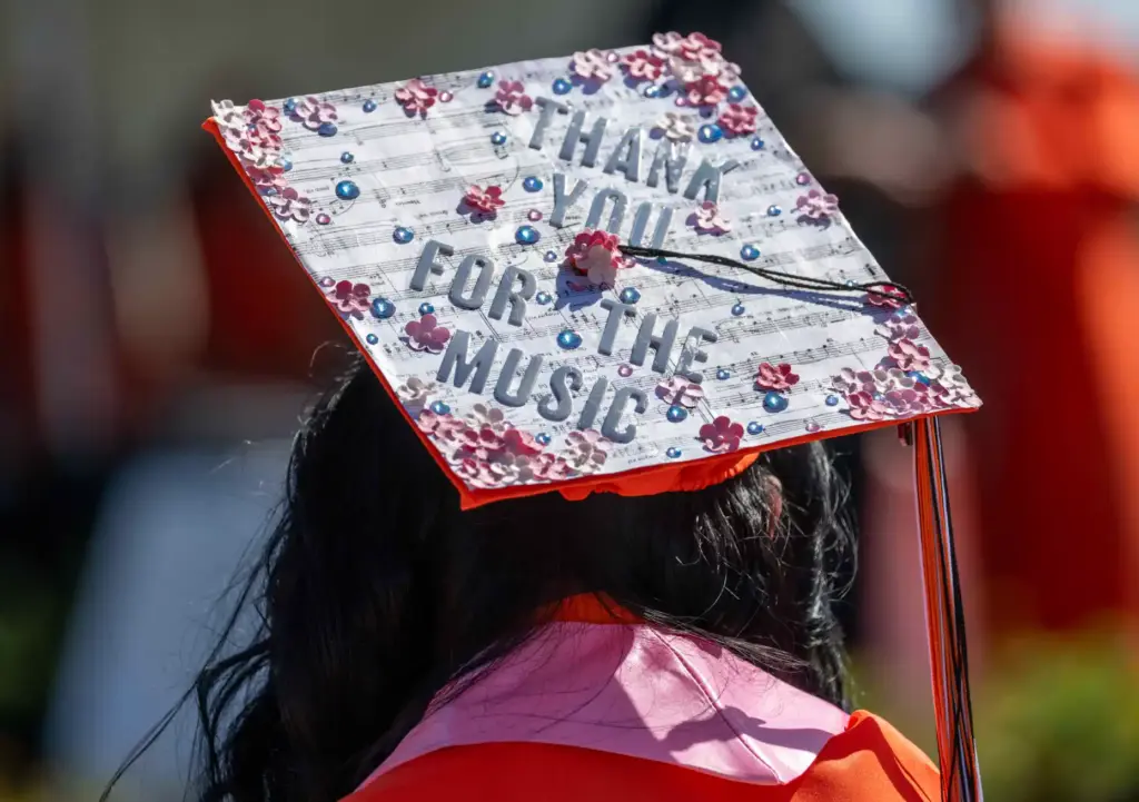 One Orange High School graduate sports a cap that reads,...