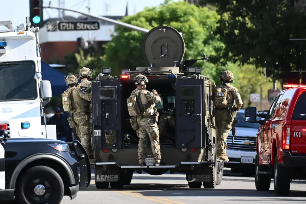 FBI agents respond after a man barricaded himself inside a...
