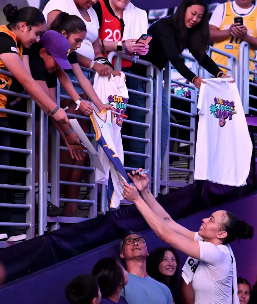 Los Angeles Sparks Dearica Hamby (5) signs a jersey for...