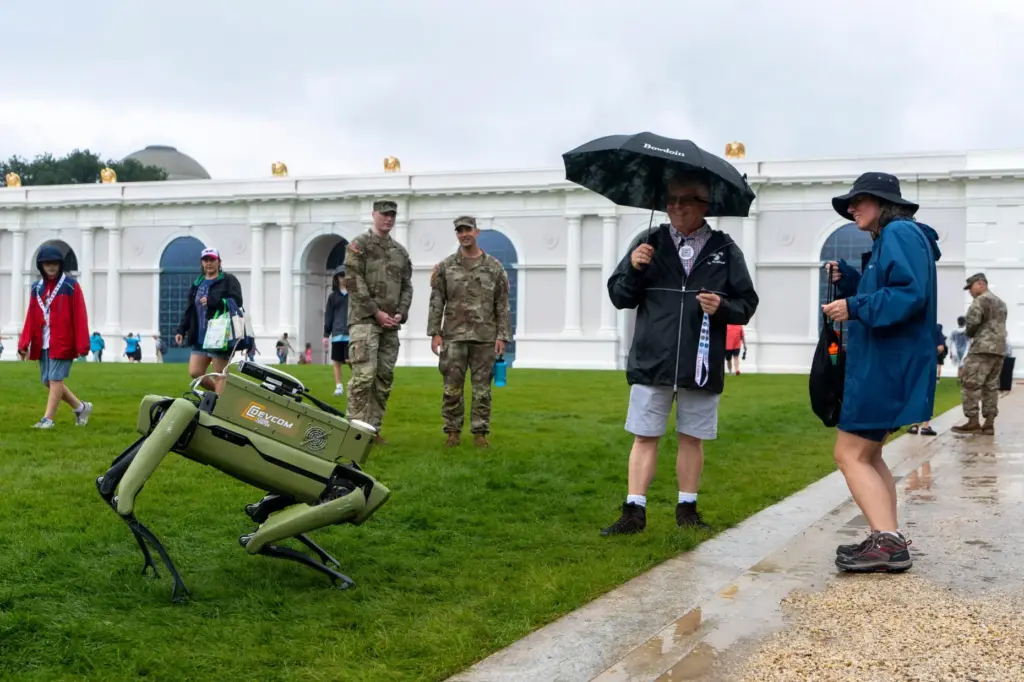 People dance with a U.S. Army robotic dog at the...