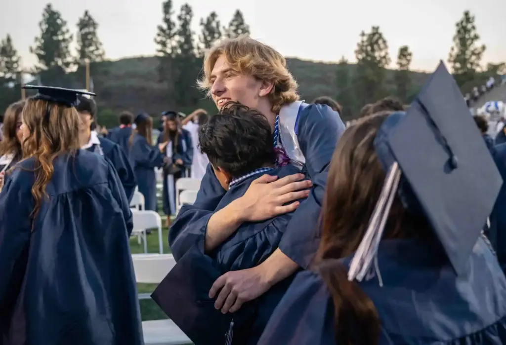 Friends celebrate together at the conclusion of their graduation ceremony...