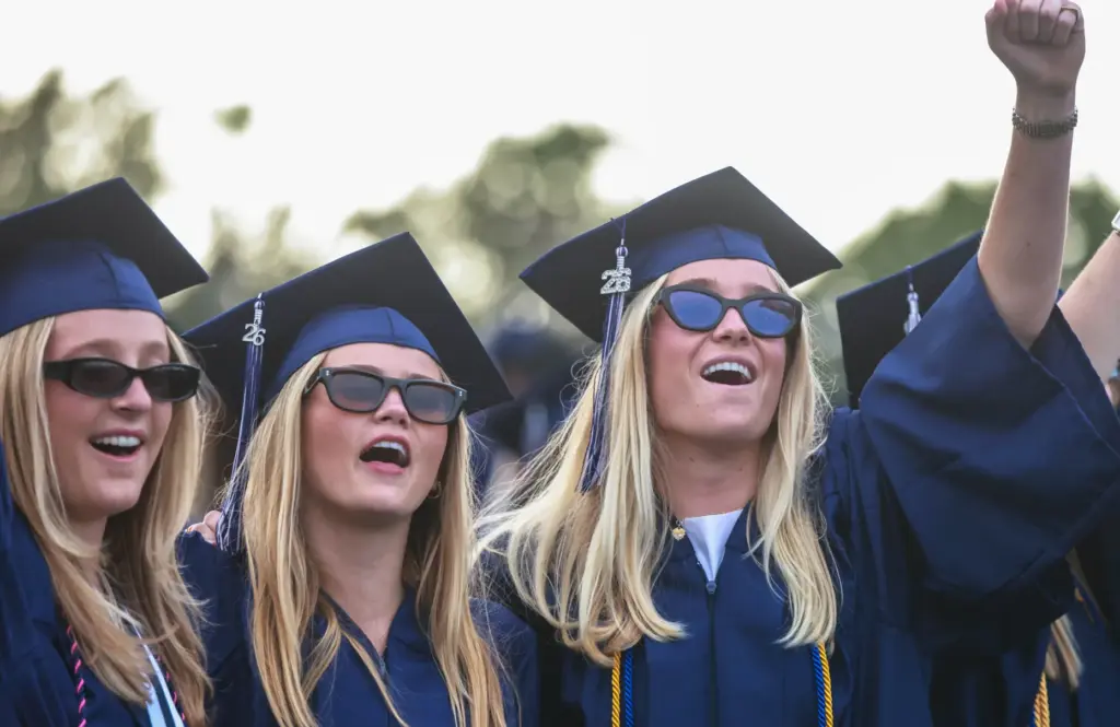Graduates sing the Alma Mater during the Newport Harbor High...