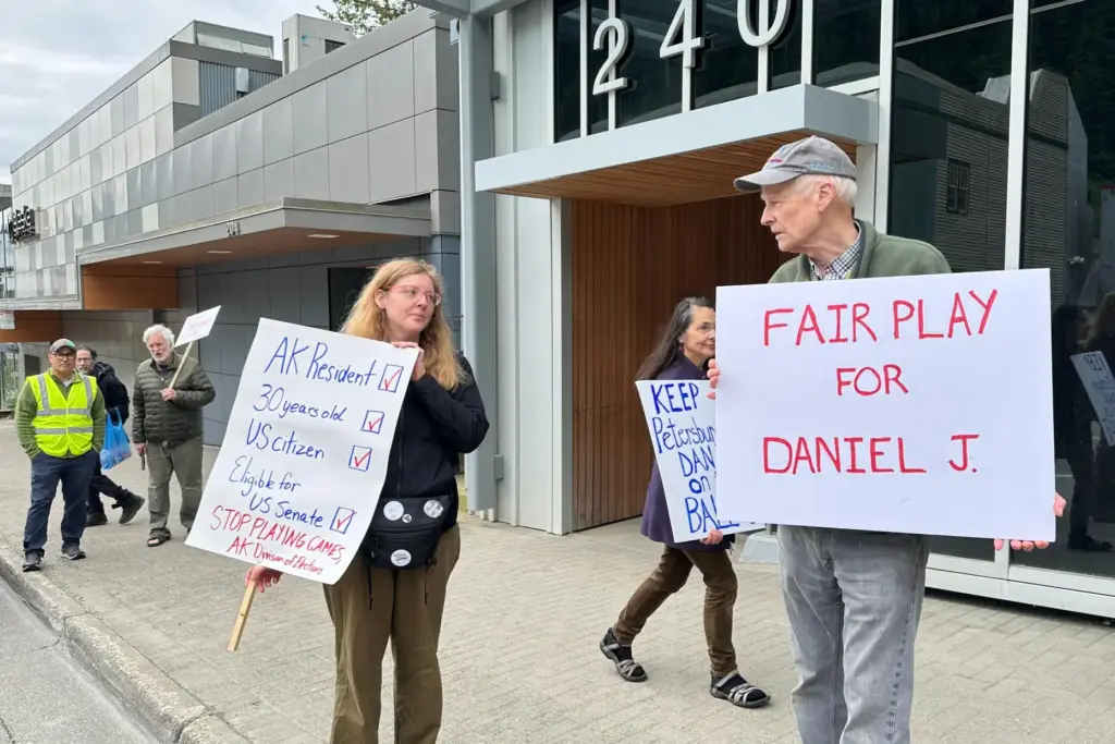 Anjuli Grantham, left, and Ben Muse protest with others outside...