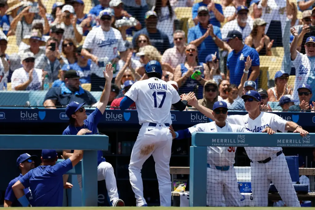Dodgers designated hitter Shohei Ohtani (17) is greeted by teammates...