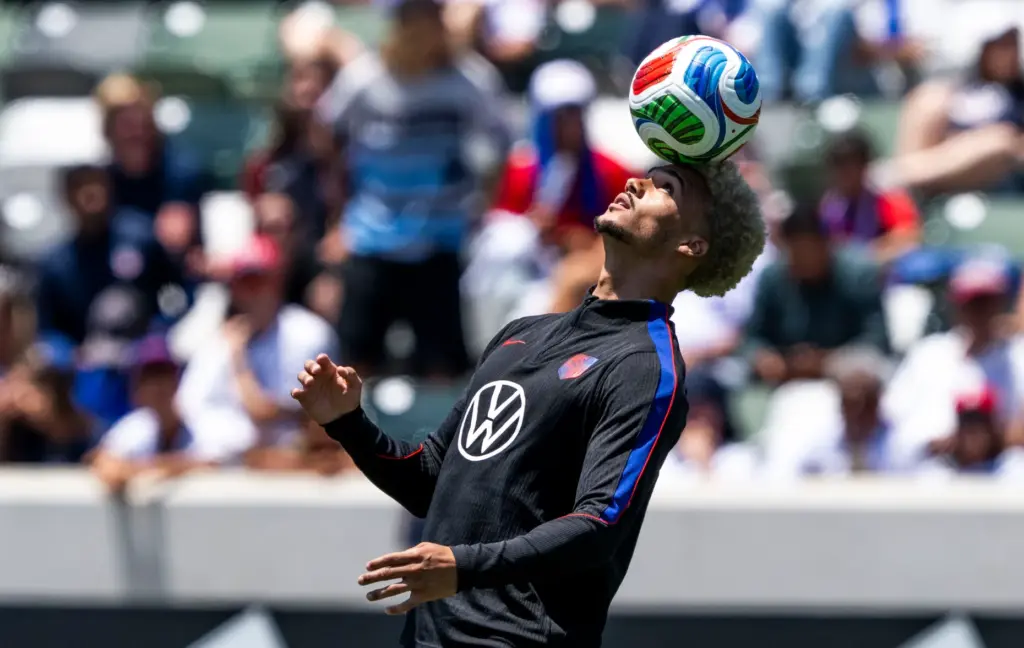 Antonee Robinson balances a ball on his head at the...