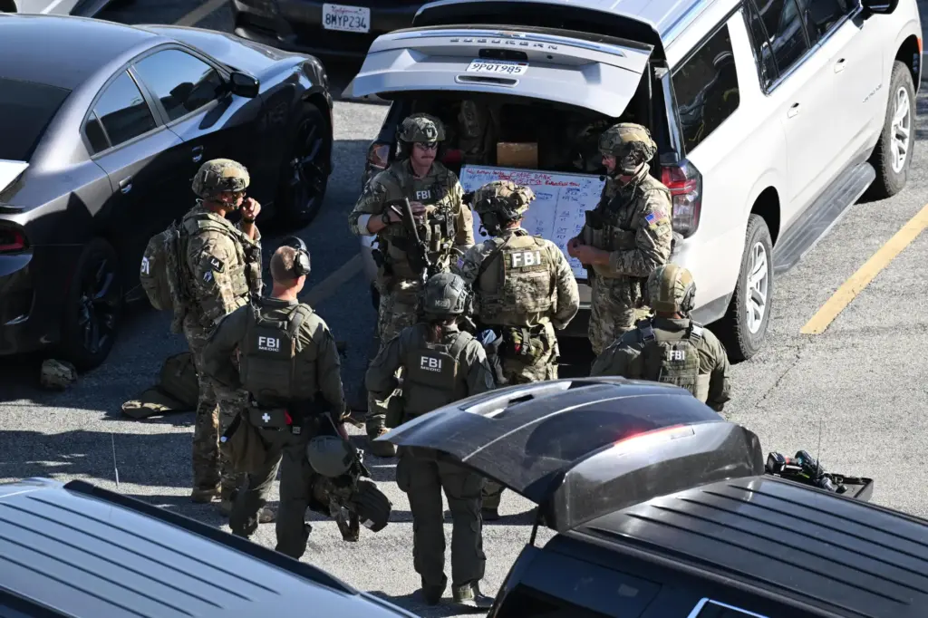 FBI agents respond after a man barricaded himself inside a...