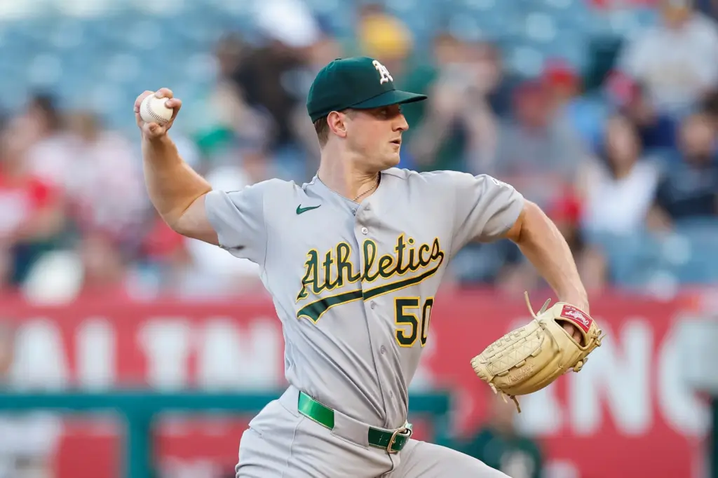 Athletics starting pitcher Jack Perkins (50) throws during the first...