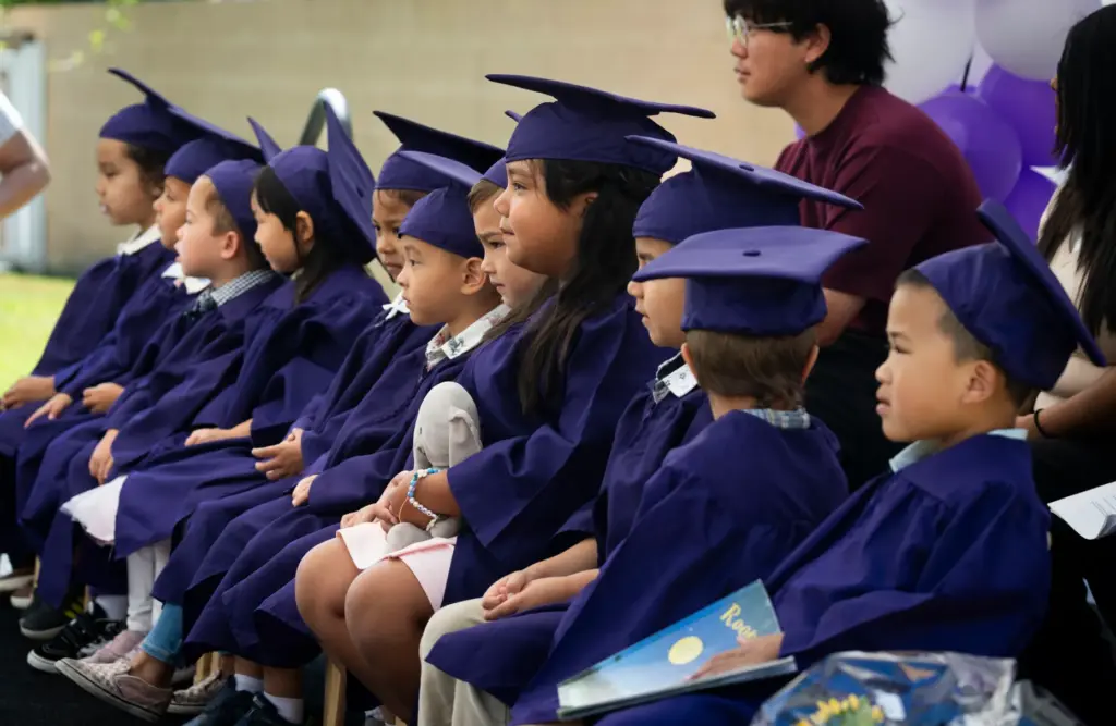 Students listen to speakers during their preschool promotion ceremony at...