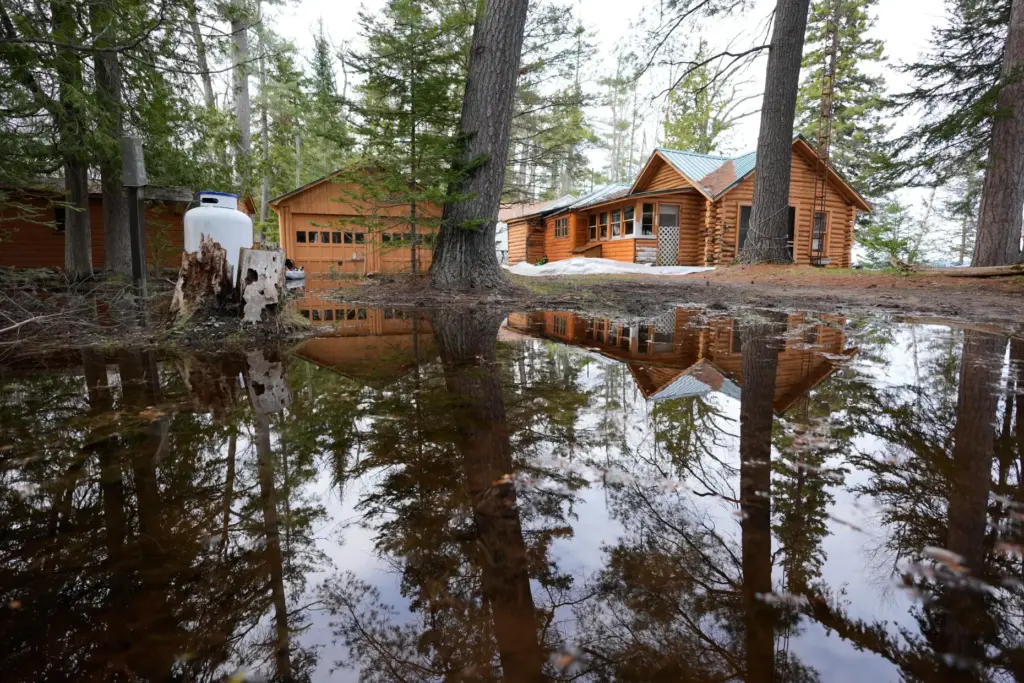A home is surrounded by water from recent floods at Black Lake.