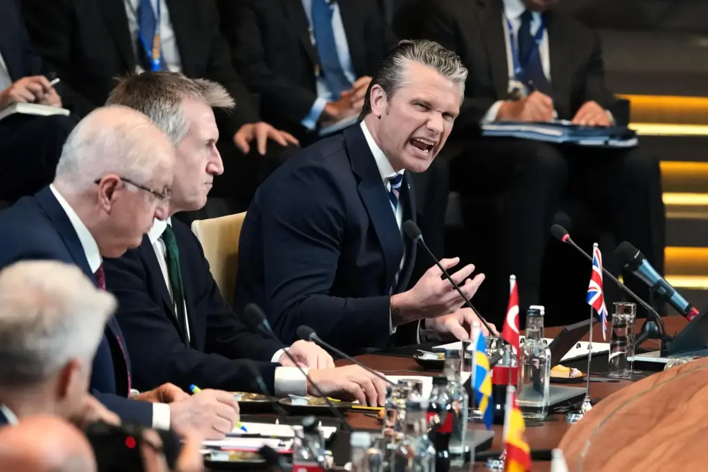 United States Defense Secretary Pete Hegseth, right, speaks during a...