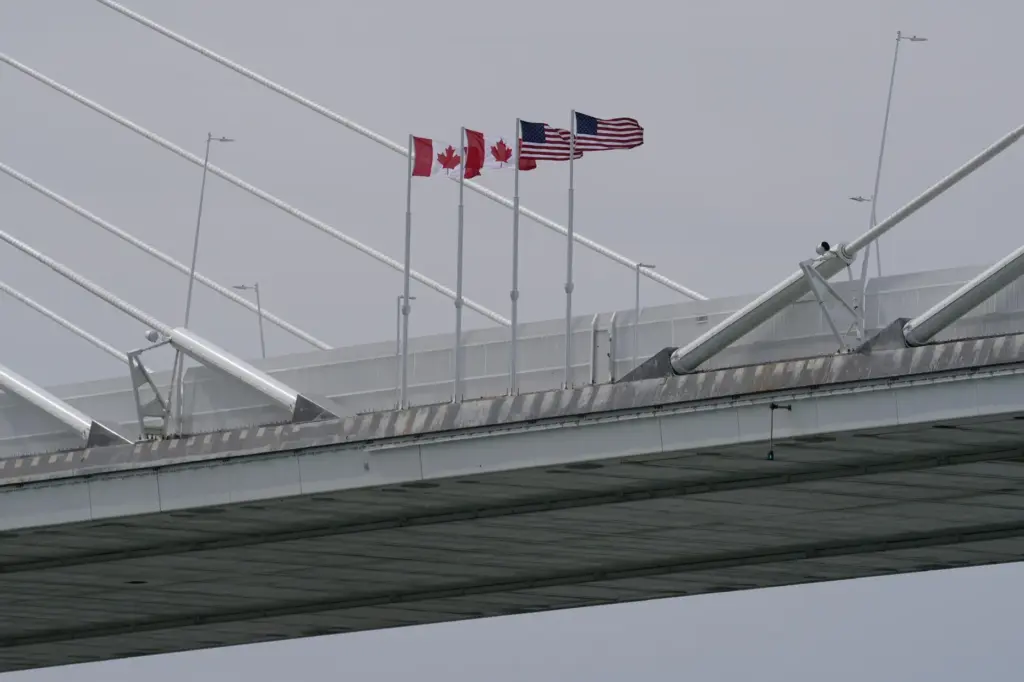 Canadian and American flags are shown on the Gordie Howe Bridge.