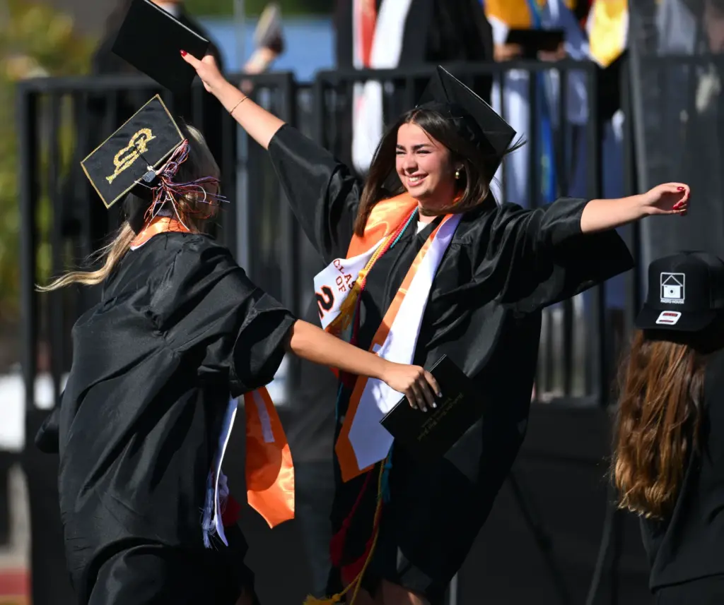 Graduates show your enthusiasm after receiving their diploma during the...