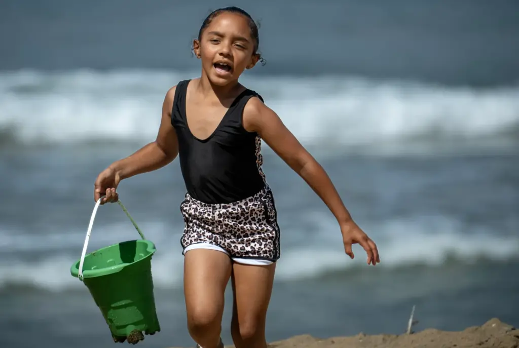 Six-year-old Mya Ali, plays with a plastic bucket borrowed from...