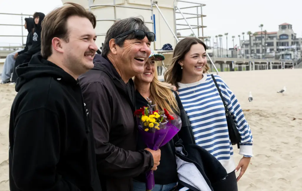 Huntington Beach High School surfing coach Andy Verdone, second from...