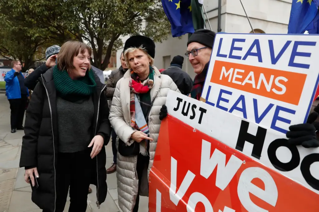 FILE – British conservative lawmaker Anna Soubry, centre, who campaigned...