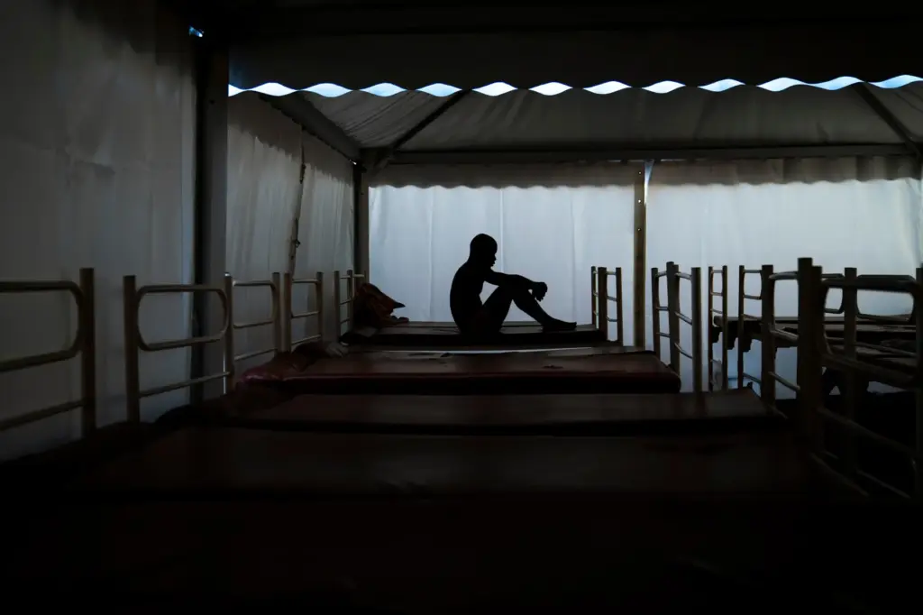 Mamadou Patherazi, from Guinea, sits on a bench at the Modern Christian Mission church.