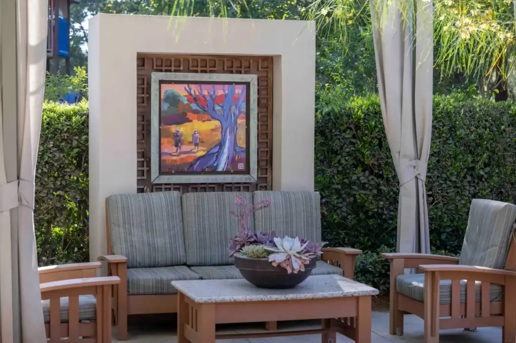 An acrylic painting by artist Laura Green decorates a sitting...