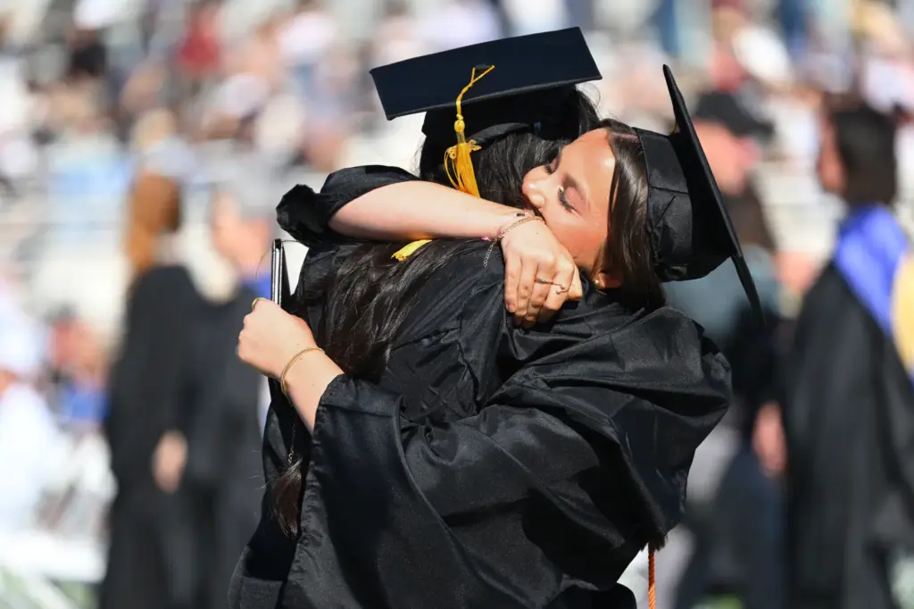 Graduates Poppy Crowther-Townsend and Mia Quinonez celebrate after getting their...