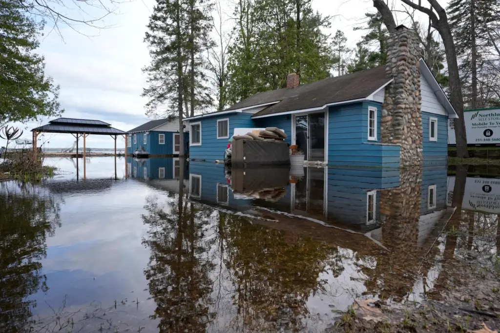 A home is surrounded by water from recent floods at Black Lake.