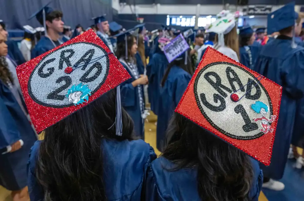 Twins Korina Bao, left, and Kianna Bao wear caps that...