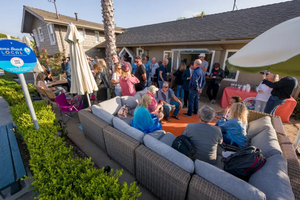 Laguna Beach residents gather for a ribbon-cutting celebration for KXFM...
