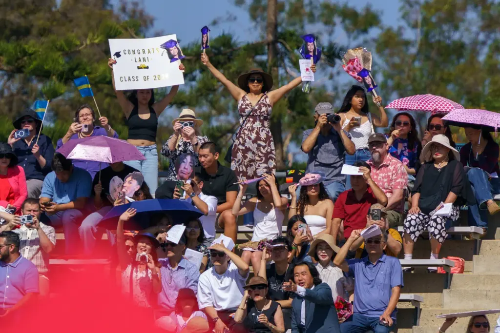 Family members wave to their senior during Woodbridge High Schoolâs...