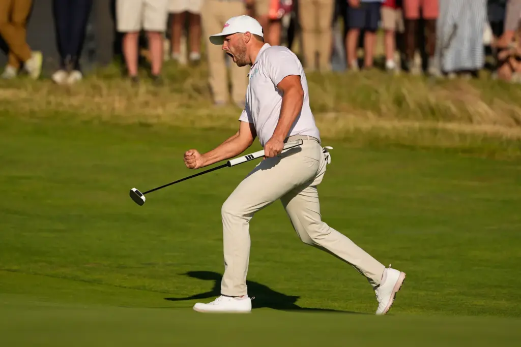 Wyndham Clark celebrates after a birdie on the 16th hole...