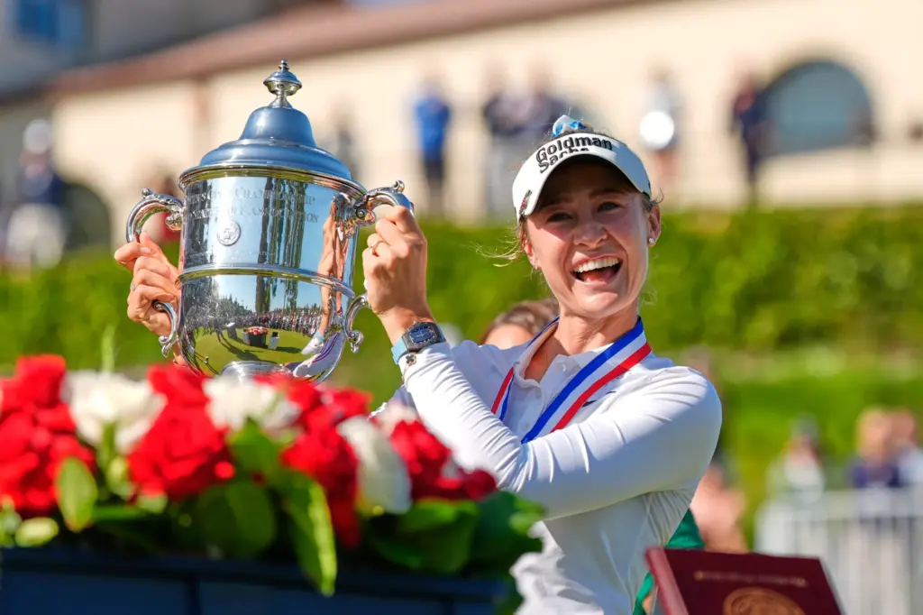 Nelly Korda holds up the trophy after winning the U.S....
