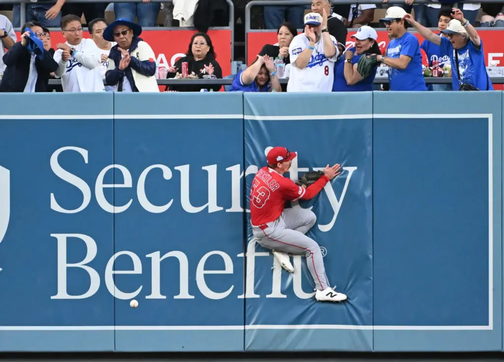 Leftfielder Wade Meckler #53 of the Angels slams into the...