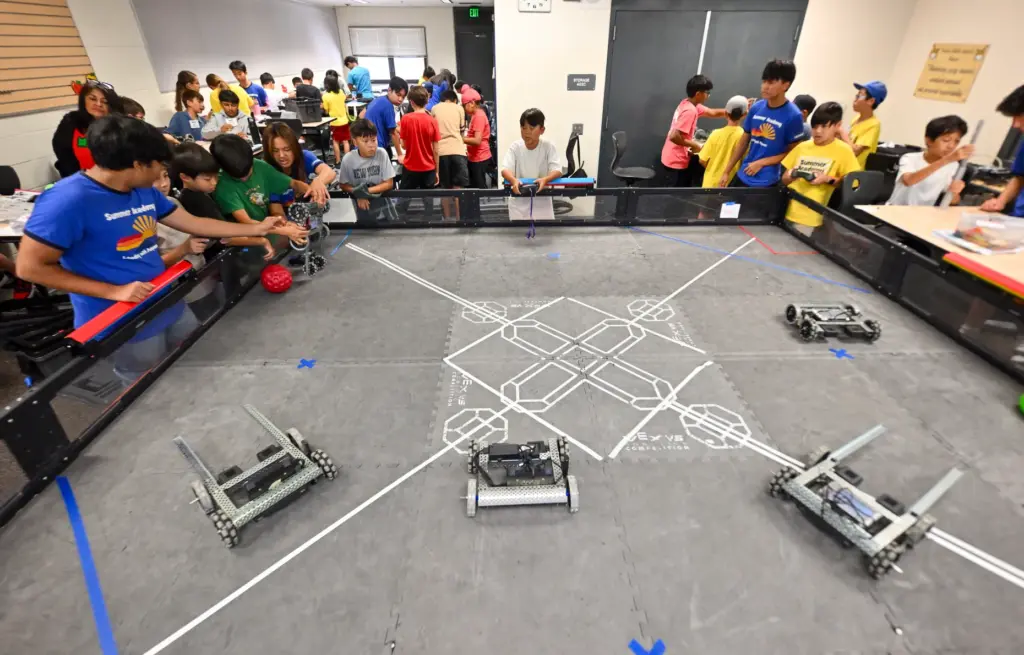 Campers prepare for robot soccer at the Tustin Summer Academy...