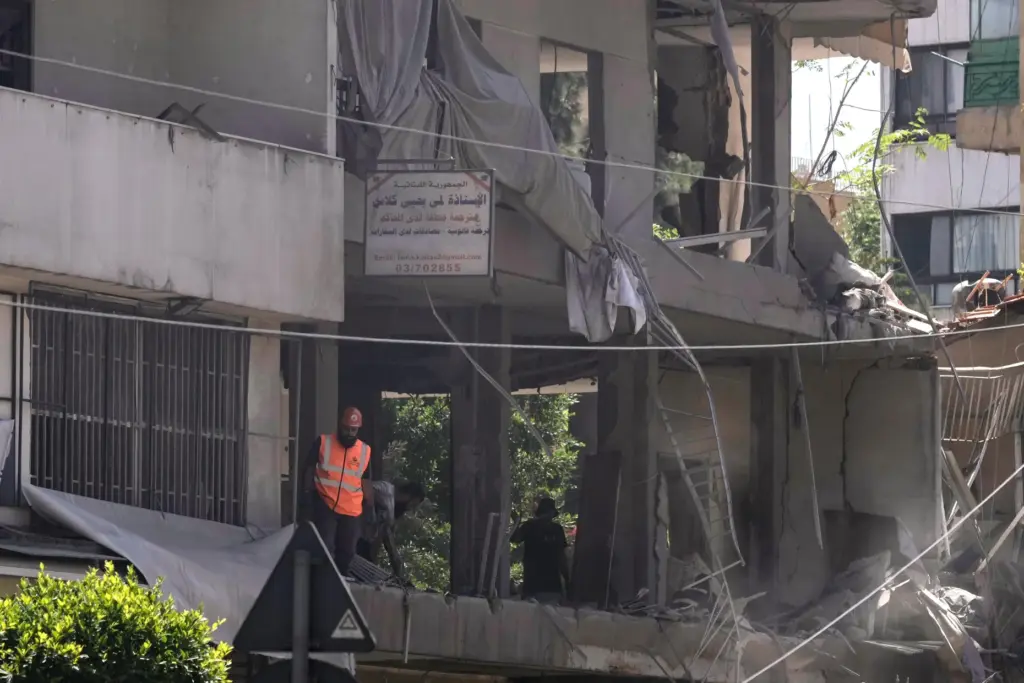 A rescue worker checks an apartment that was hit in an Israeli airstrike.